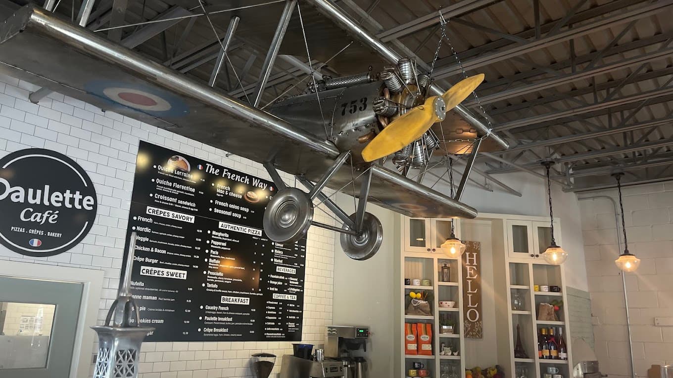 Paulette Cafe interior with menu boards and Eiffel Tower decor